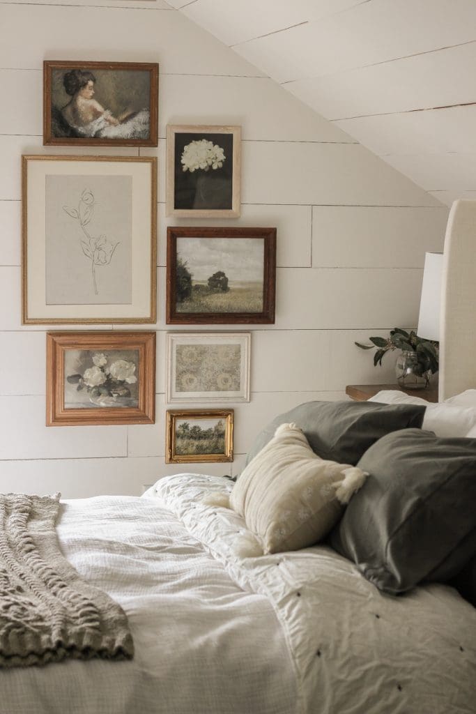 Vintage Interior Design image of loft style bedroom with white slatted wood walls and a vintage frame and picture gallery wall