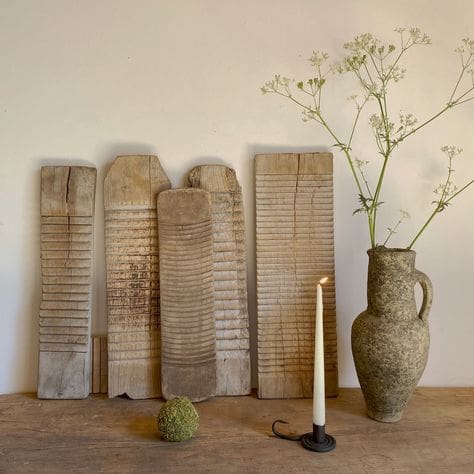 Antique washboards of oak wood, tall pillar candle and rustic vase