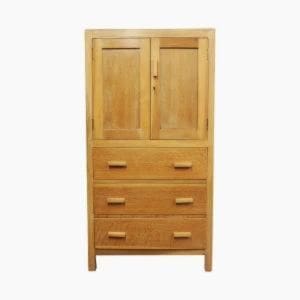 Tall medium0oak Mid-Century cabinet with 3 drawers to the bottom and cupboard space above