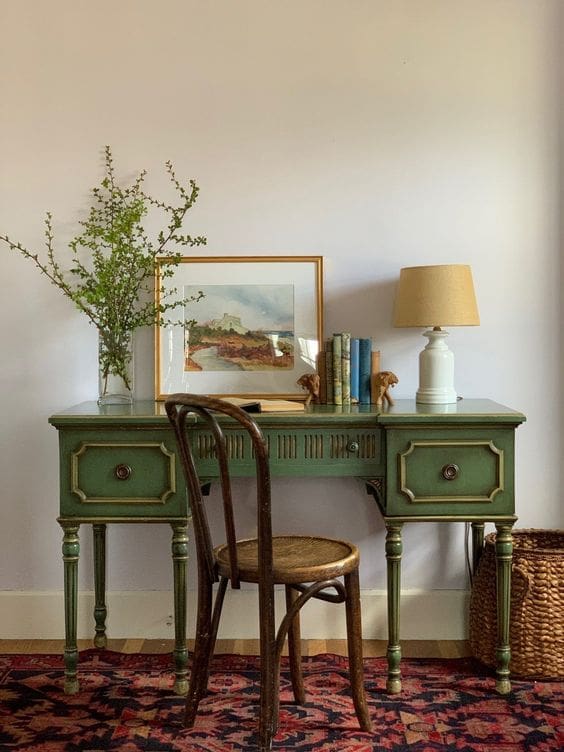 vintage furniture. green desk with dark wood cafe style chair.