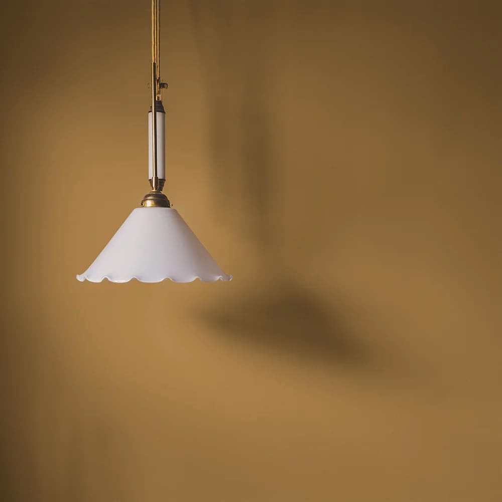 Dark yellow ochre painted wall with white scallop edge ceiling pendant