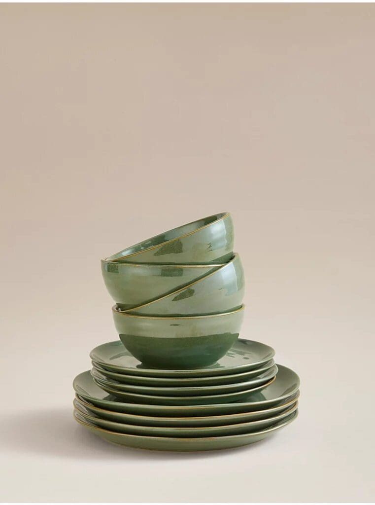 Forest green glazed stack of plates and bowls