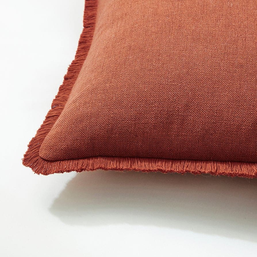 Terracotta woven cushion with frill edge