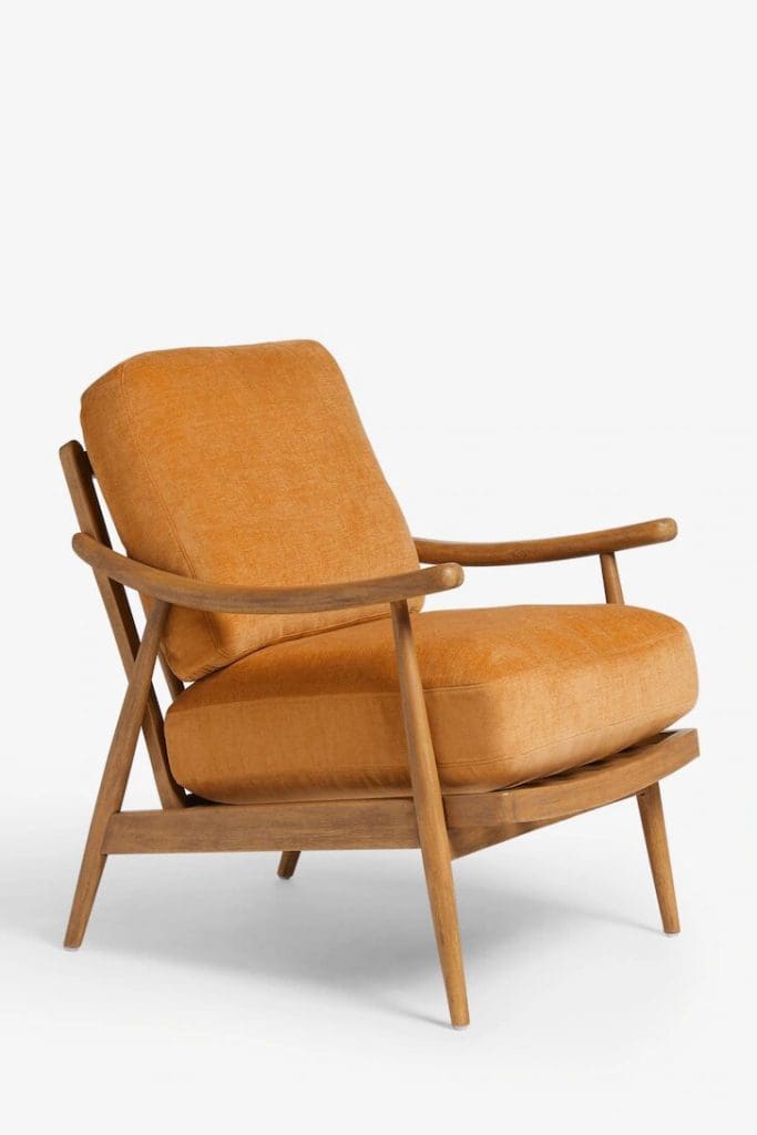 Mid Century Modern style armchair with warm wooden frame and yellow ochre seat cushion and back