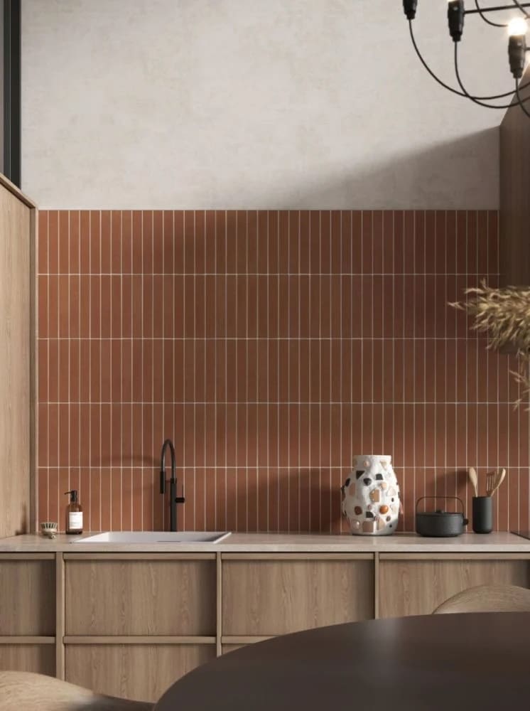 Kitchen space with warm wood cabinetry, black accent tap and terracotta thin metro tile wall feature