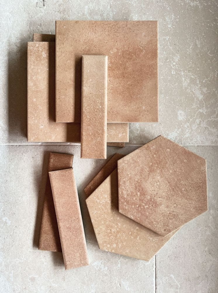 Selection of traditional terracotta tiles in varying shapes of squares, thin rectangles and hexagons.