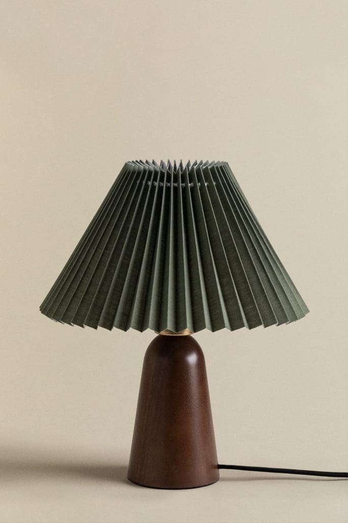 Small table lamp with dark wooden base and pleated dark forest green shade