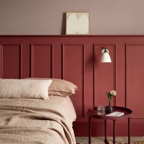 Red brick colour traditional wall panelling, half height with neutral bed and wall light