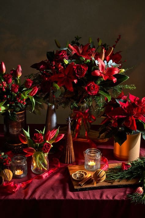 Tablescape with red poinsettias and fresh flower displays