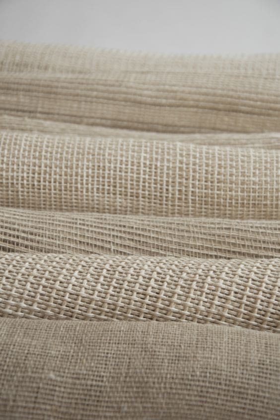 Folded and stacked neutral fabrics and woven materials