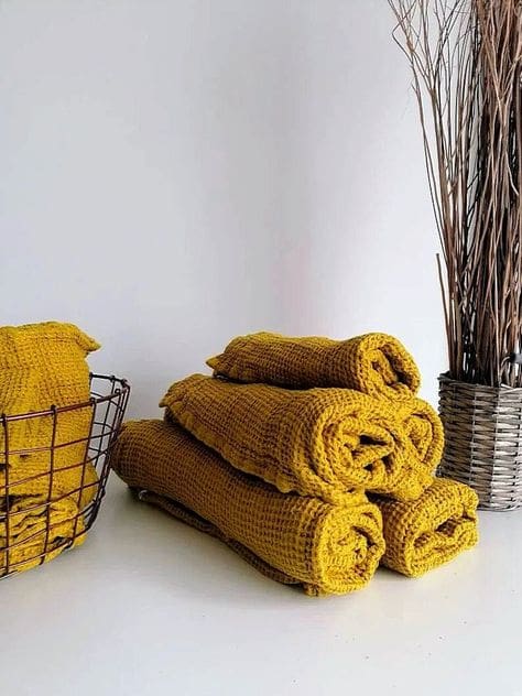 Rolled up waffle mustard yellow hand towels