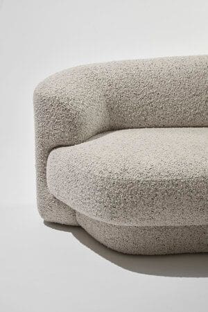 Curved boucle sofa in a warm grey and mushroom fleck finish